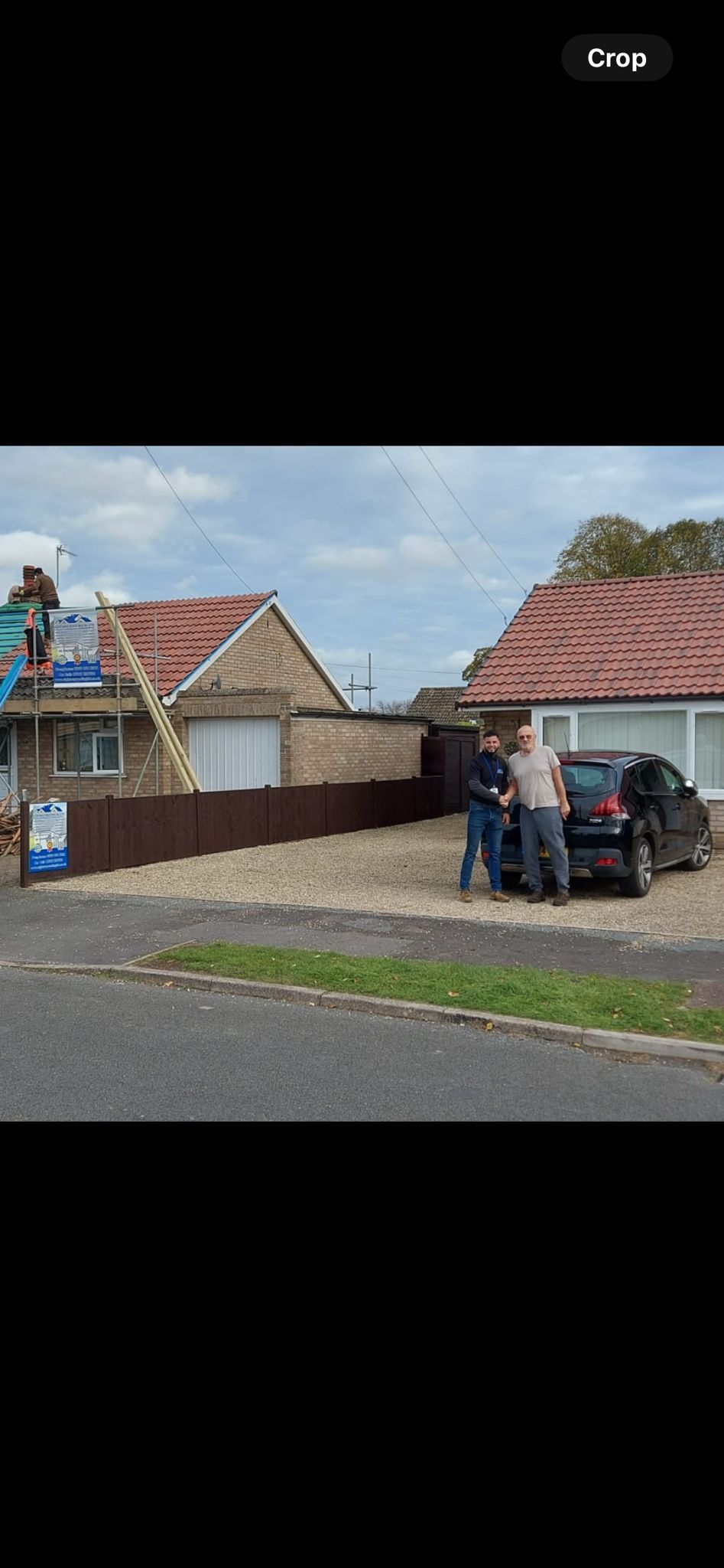 Team performing membrane installation on residential roof