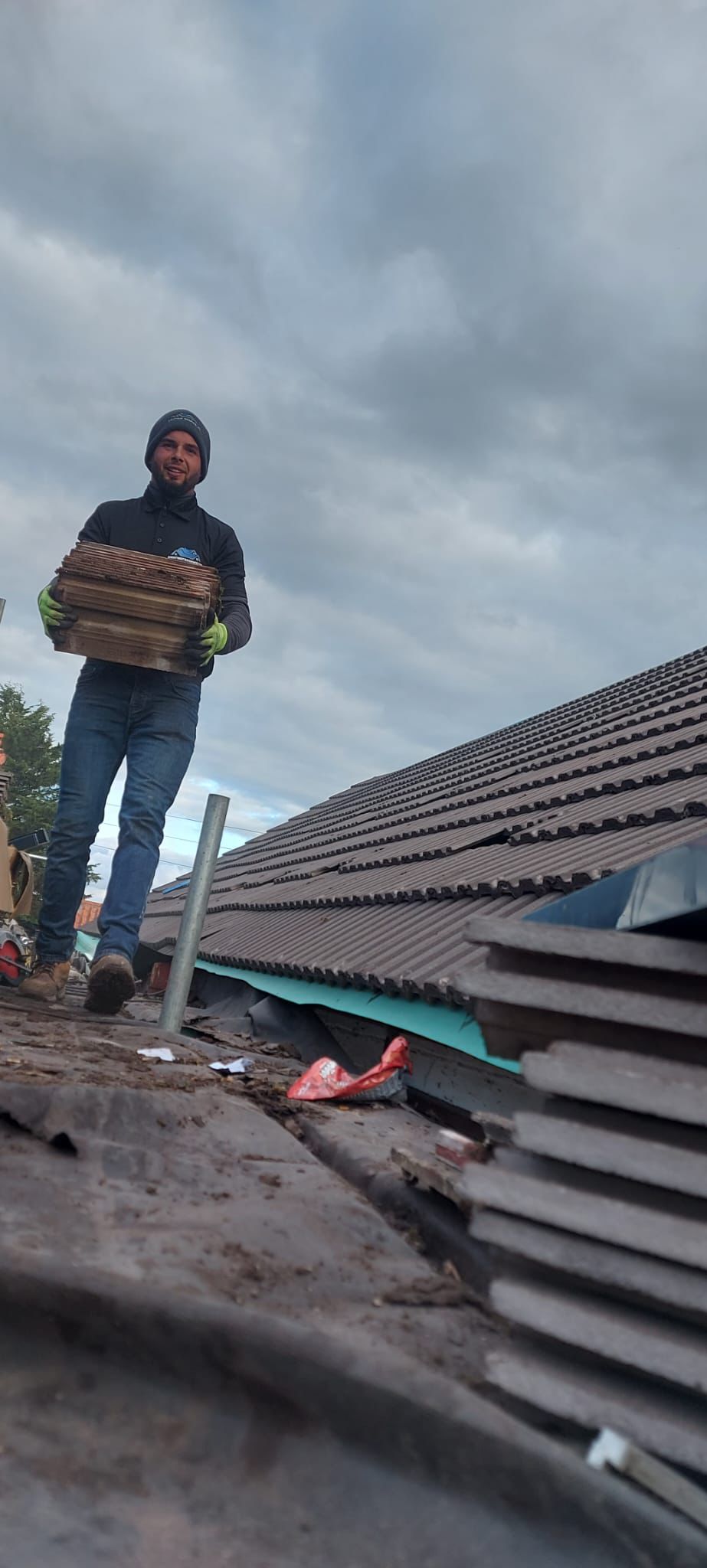 New roof installation captured at sunset with scaffolding