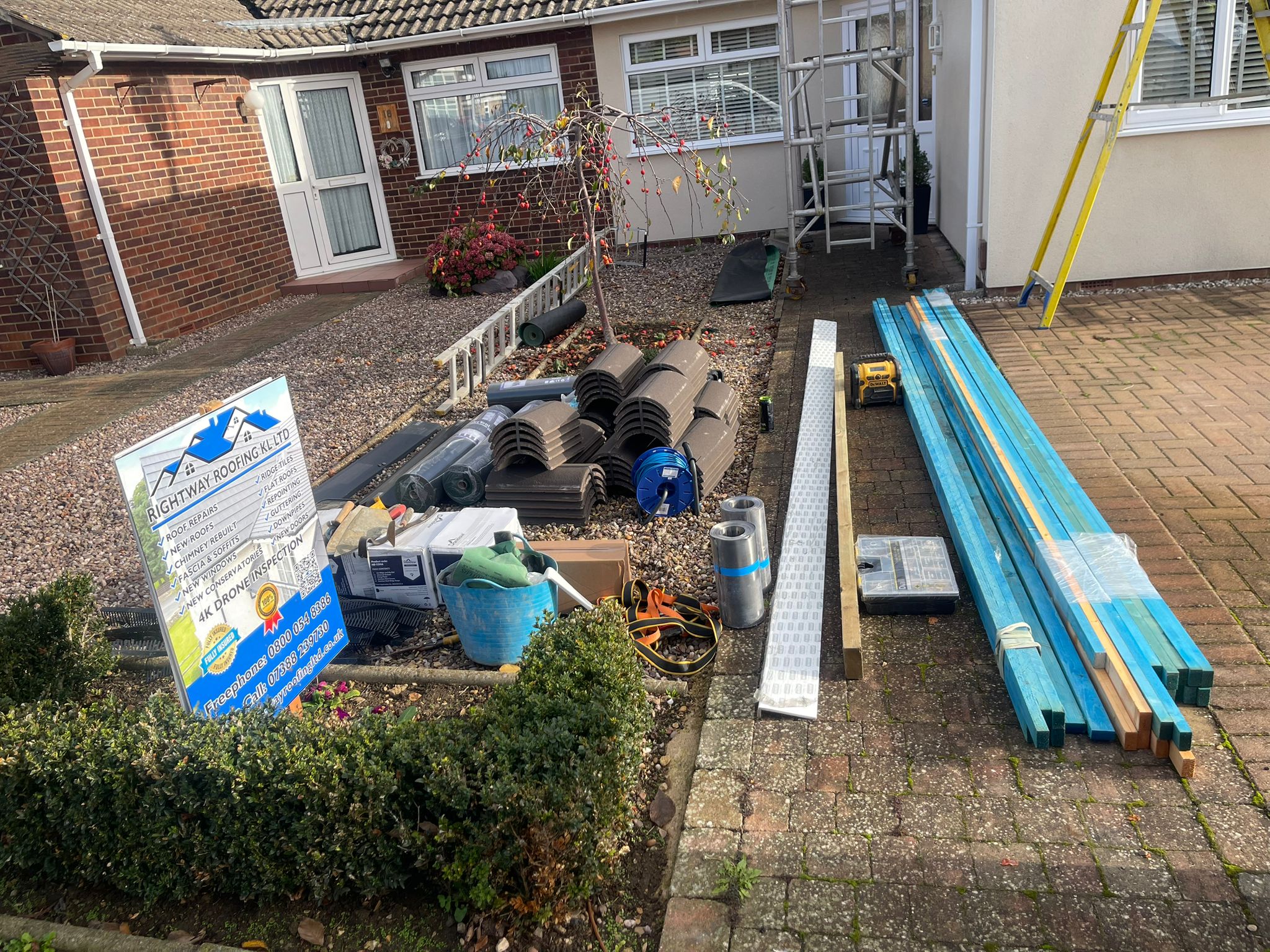 Job site setup with materials and company signage - Rightway Roofing Ltd