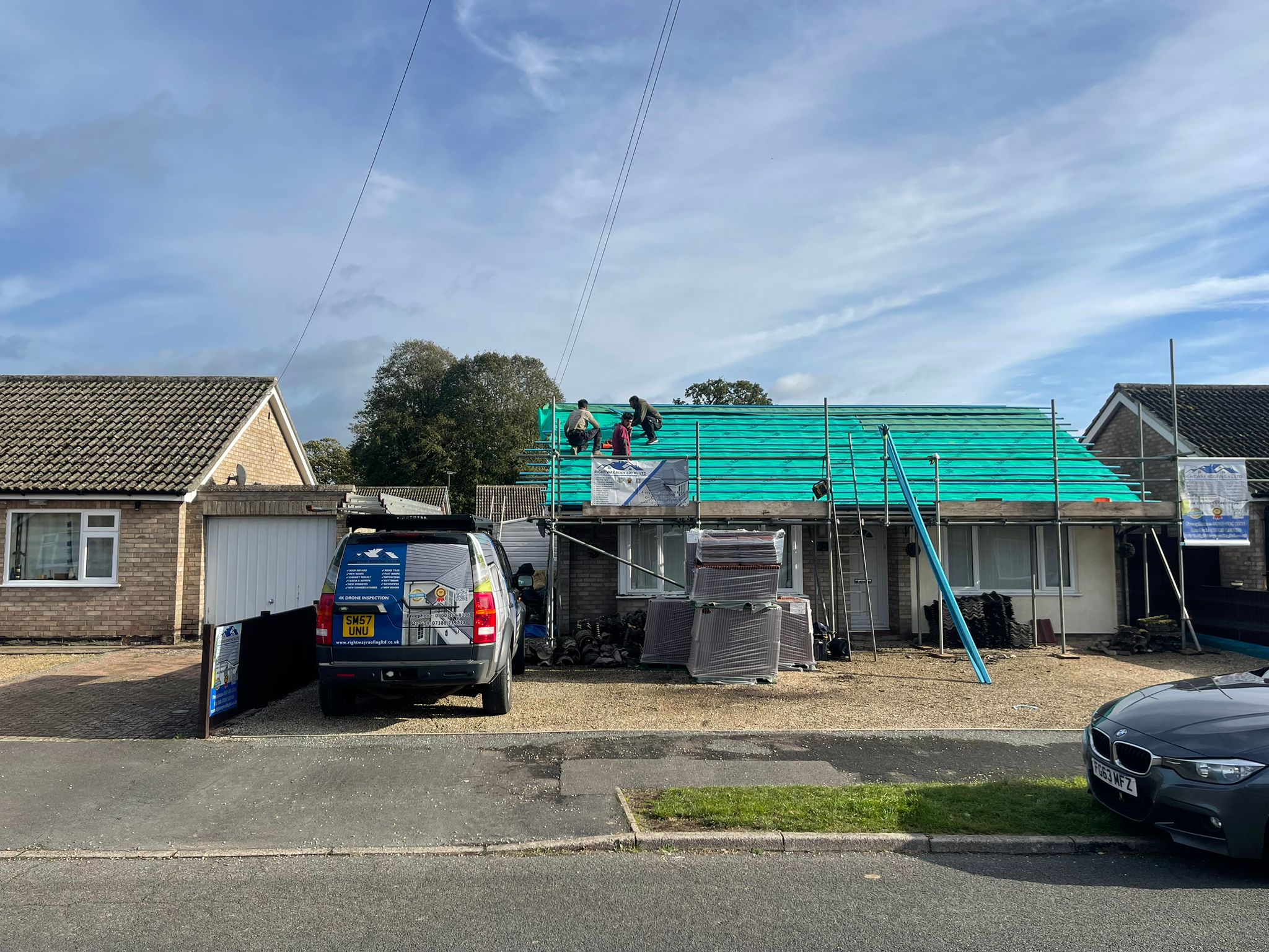 Bungalow with complete scaffolding setup for roofing