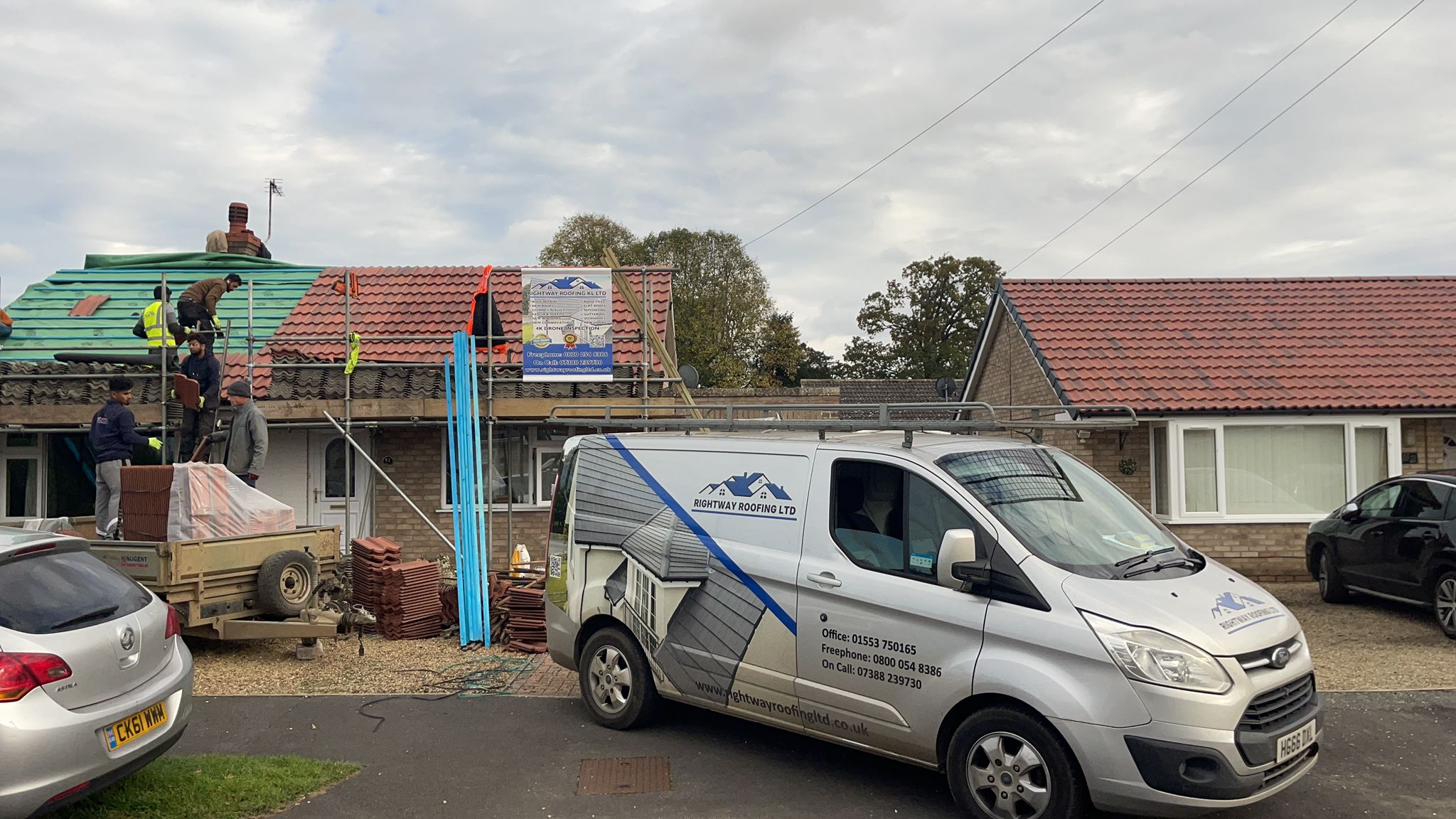 Bungalow roofing project front view with scaffolding