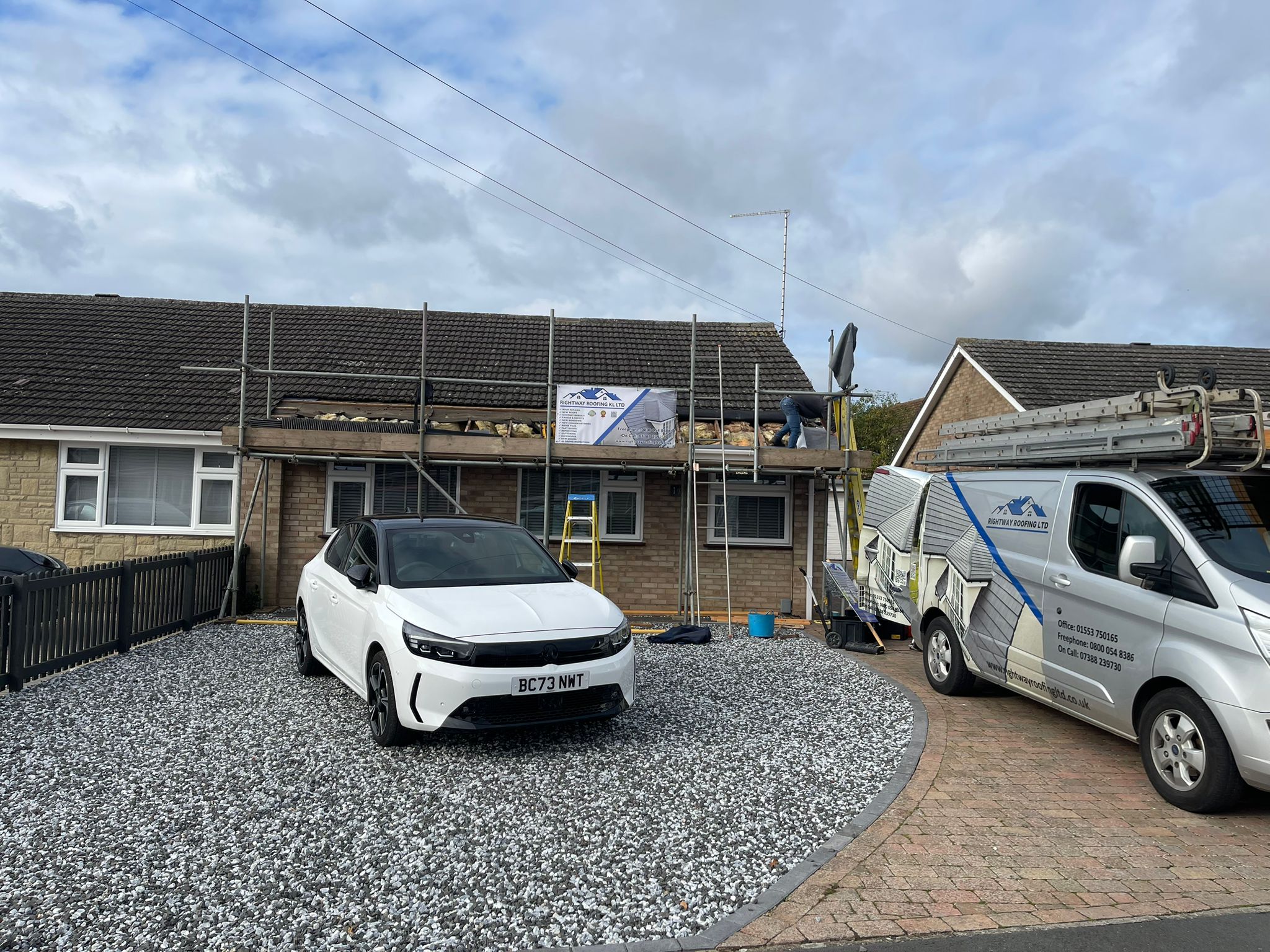 Roofer working on ridge tiles installation and repair
