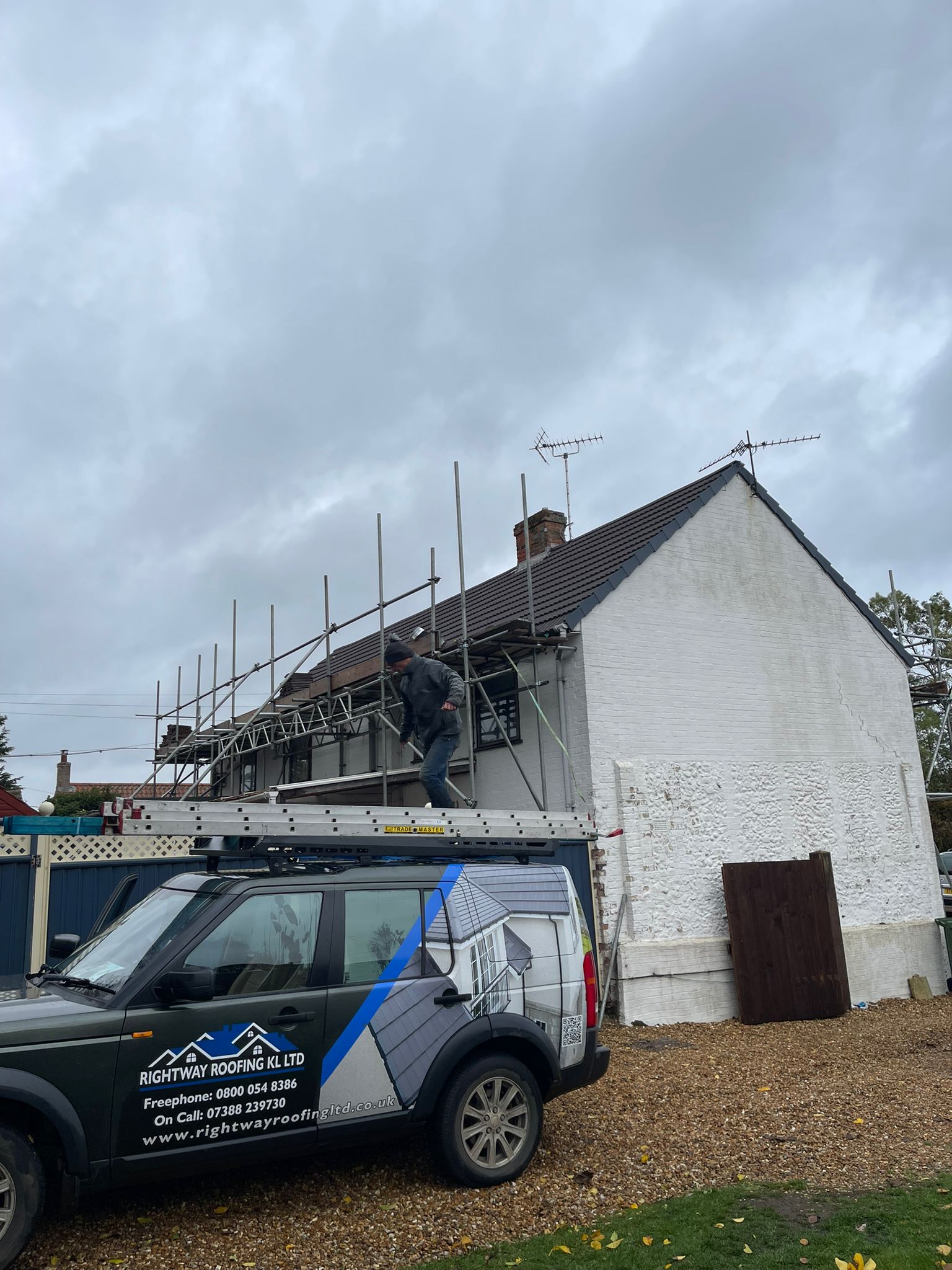 Professional roofing setup with company signage and materials