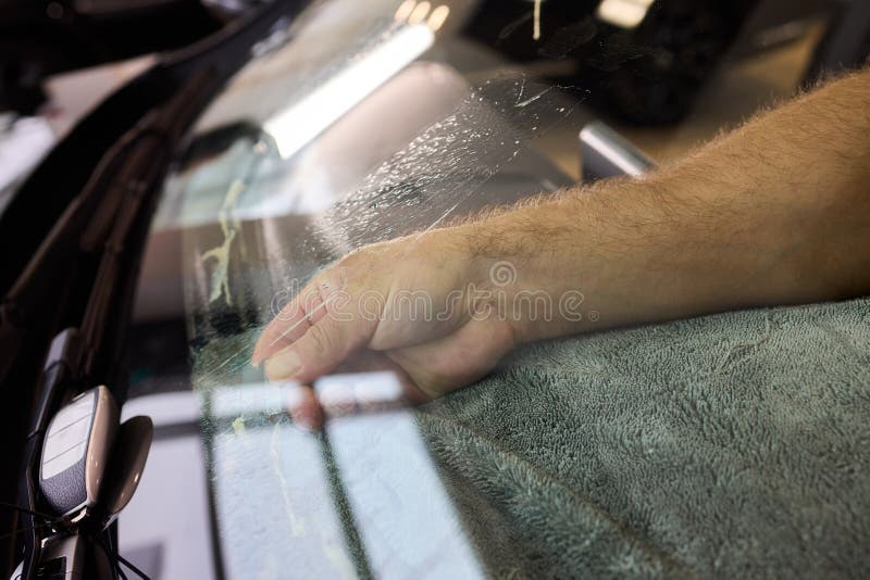 Professional window tinting being applied to luxury vehicle