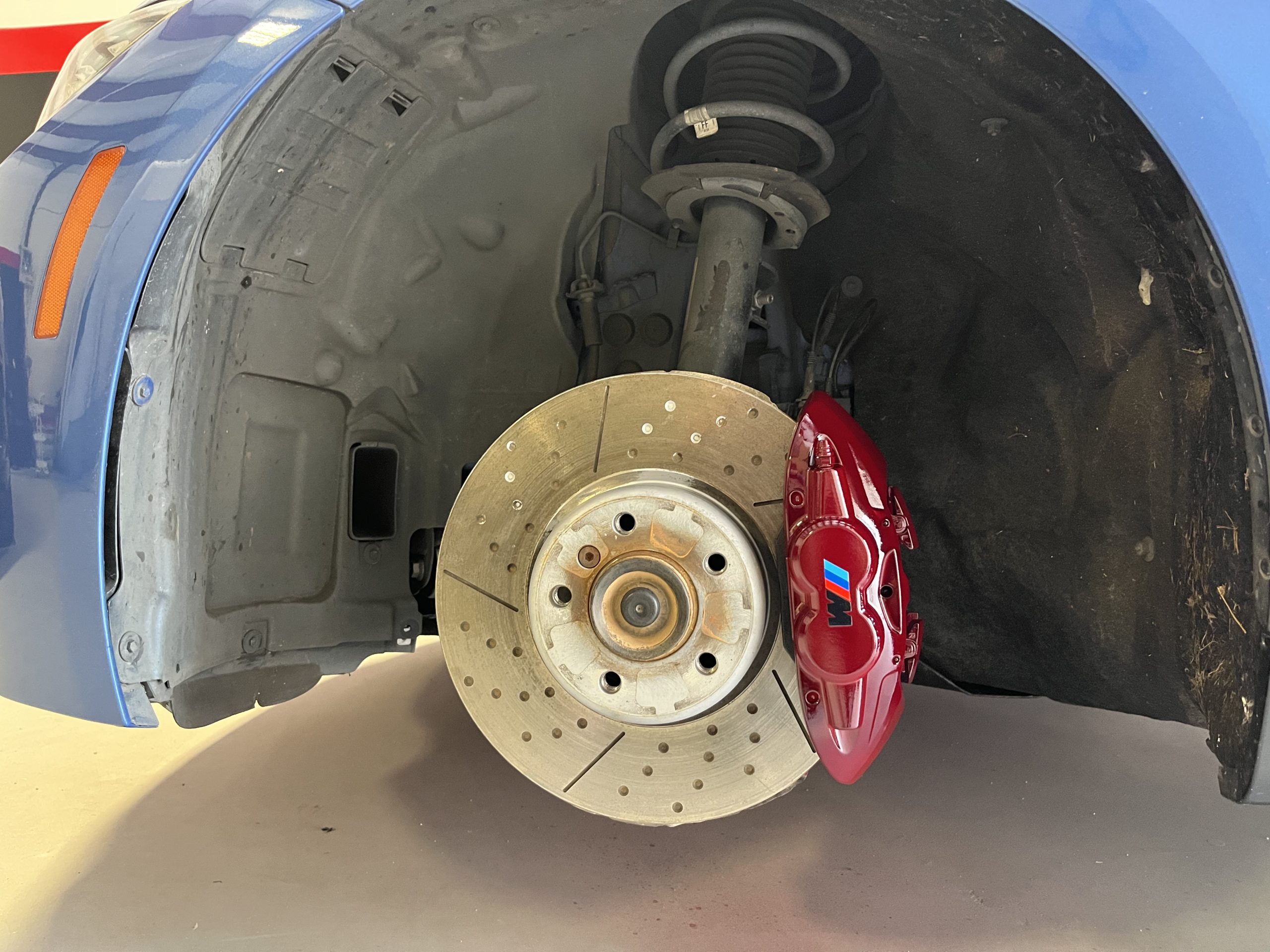 Professional technician applying paint to brake calipers