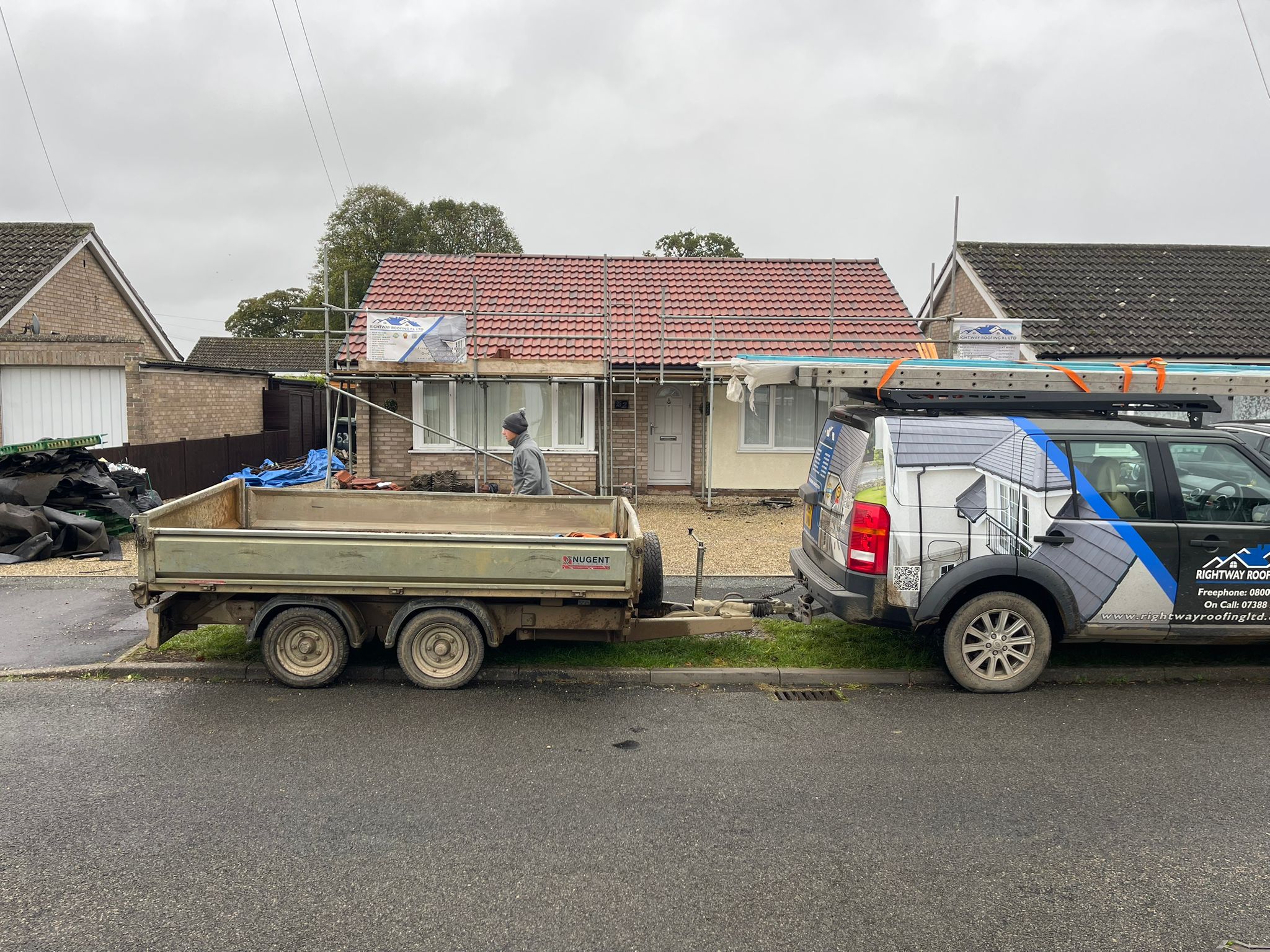 Active roofing work in progress on bungalow
