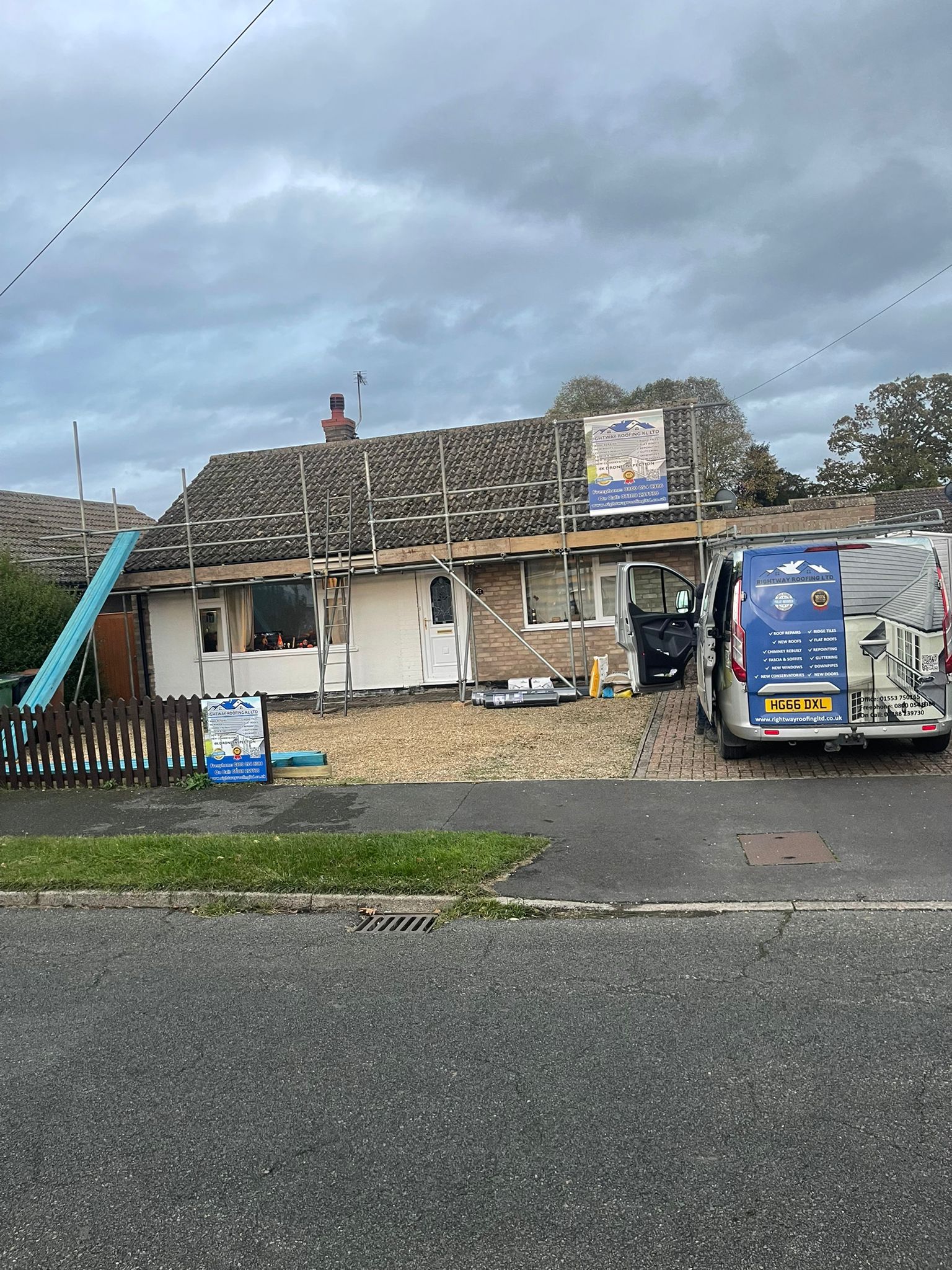 Company van and worker with materials at residential site